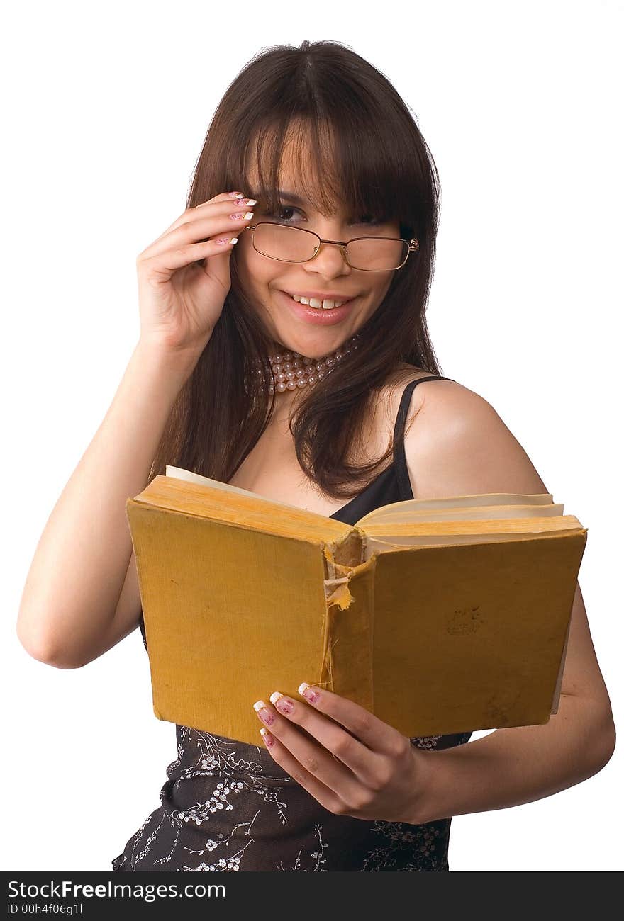 The girl in glasses reads the book on a white background. The girl in glasses reads the book on a white background