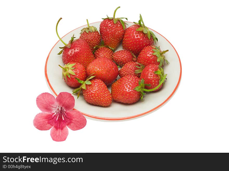 Strawberries on a saucer and a flower, isolated on white background, with clipping path in the file. Strawberries on a saucer and a flower, isolated on white background, with clipping path in the file