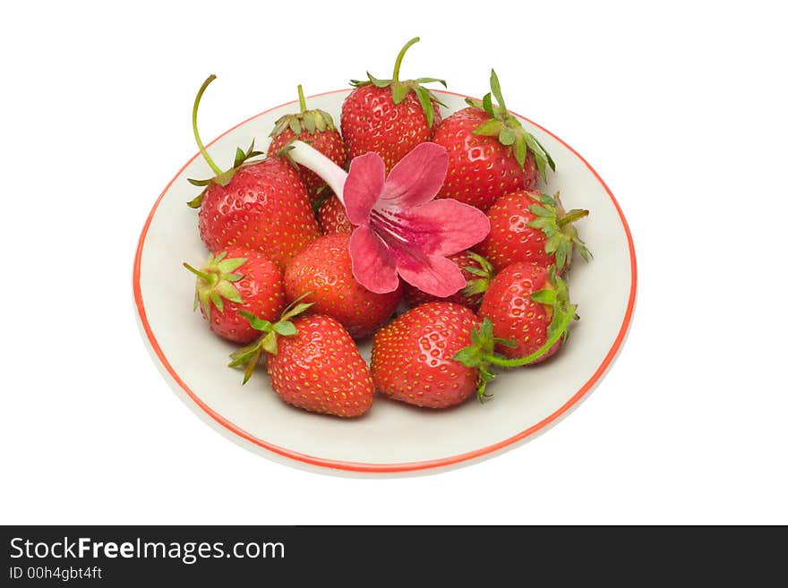 Strawberries and a flower on a saucer, isolated on white background, with clipping path in the file. Strawberries and a flower on a saucer, isolated on white background, with clipping path in the file