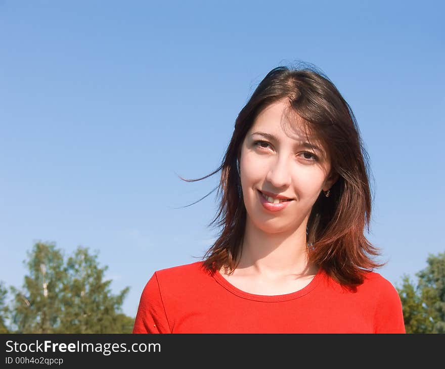 Portrait of the young attractive girl with an attractive smile and a happy look.