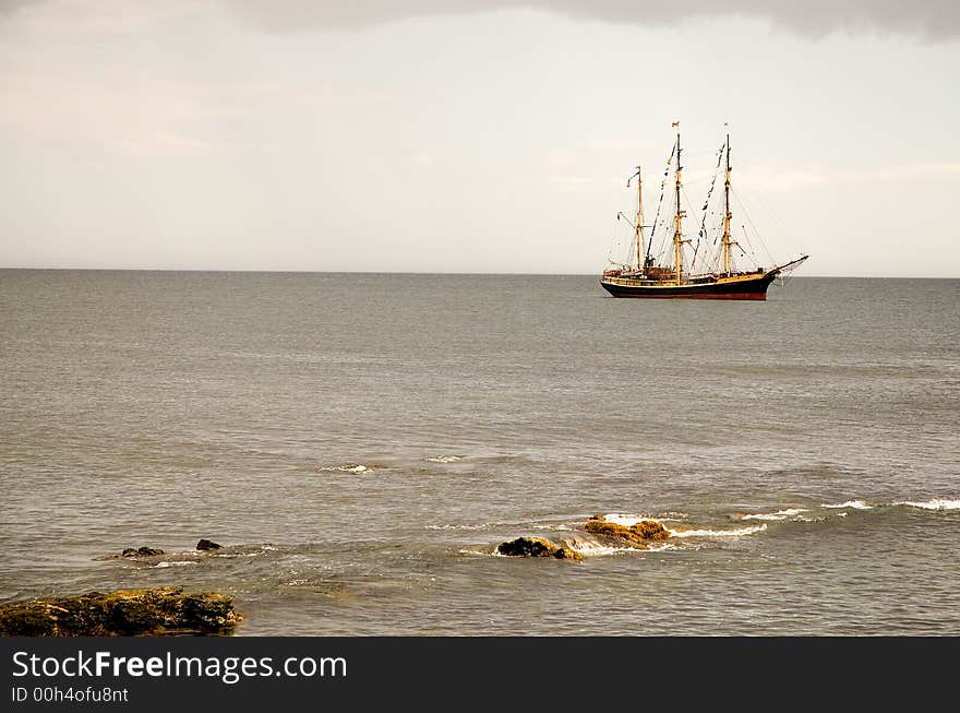 A view of a large sailboat or schooner anchored just off the Atlantic coast in Newport, Rhode Island. A view of a large sailboat or schooner anchored just off the Atlantic coast in Newport, Rhode Island.