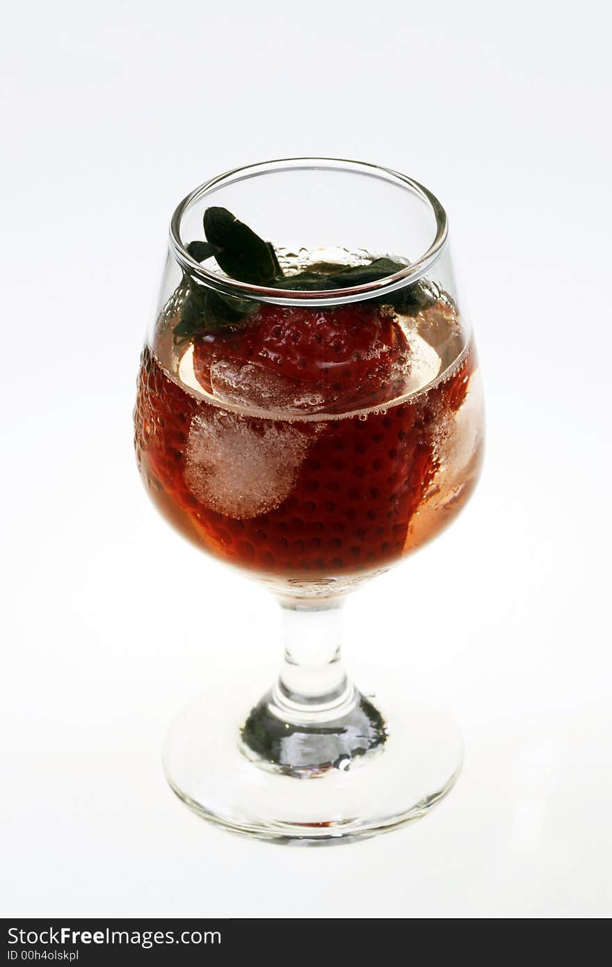 Single strawberry in a glass with ice on white background. Single strawberry in a glass with ice on white background