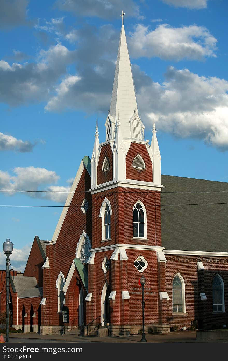 Iconic Brick Church with white Steeple toped with a Cross. Iconic Brick Church with white Steeple toped with a Cross