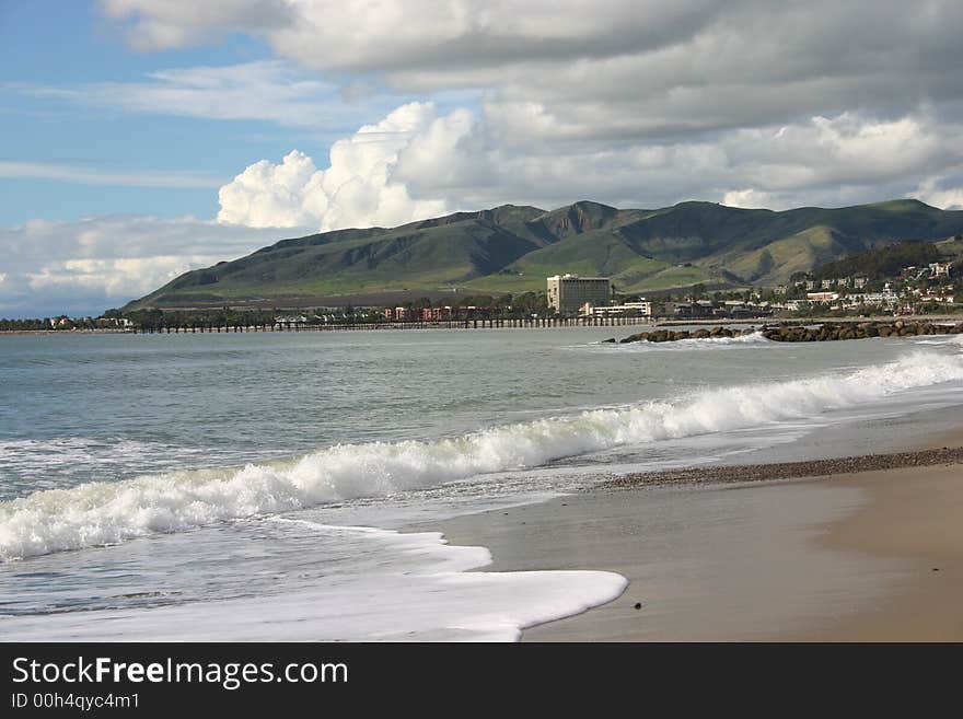 The coastline, surf foam, and breaking waves make a beautiful picture on a cloudy  but sunny day. The coastline, surf foam, and breaking waves make a beautiful picture on a cloudy  but sunny day.