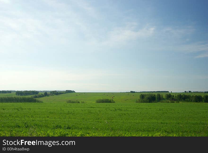 Meadow landscape with cloudscape and haystacks. Meadow landscape with cloudscape and haystacks