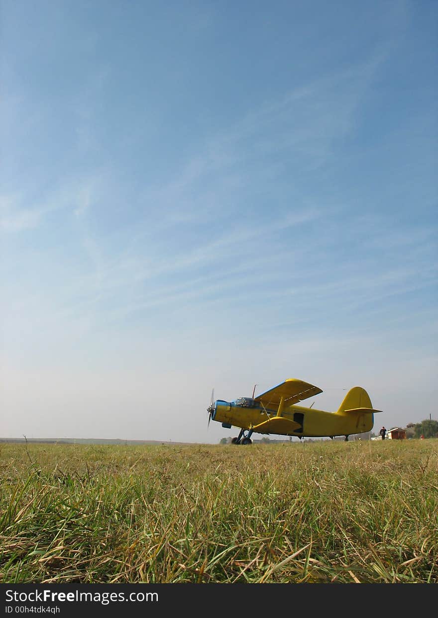 The plane flies up on a field, the blue sky. The plane flies up on a field, the blue sky