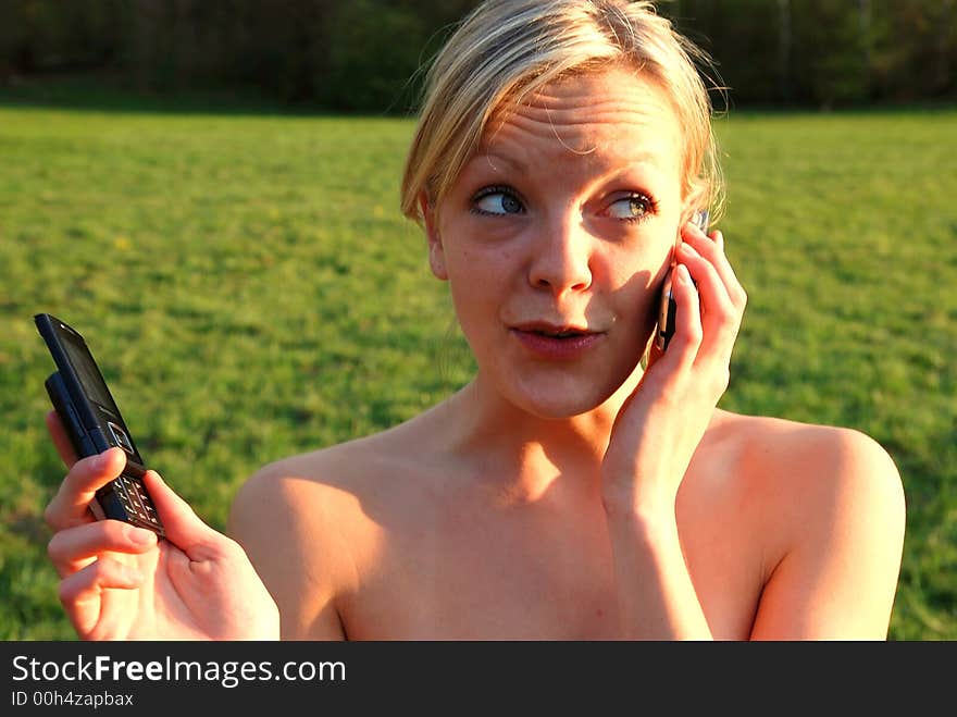 Girl is phoning outside with her friends. Girl is phoning outside with her friends