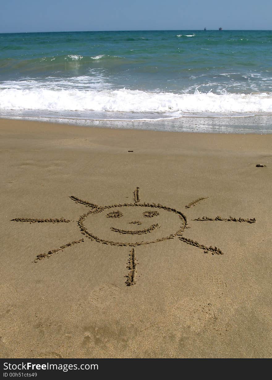 Beach with a sun drawing in the sand. Beach with a sun drawing in the sand