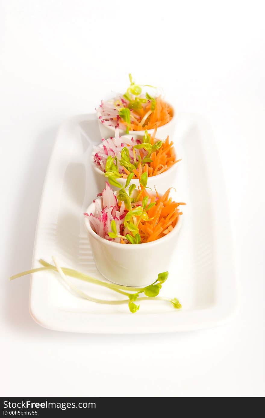 Carrot and radish salad in white bowls. Carrot and radish salad in white bowls