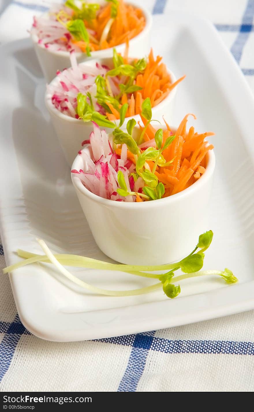 Carrot and radish salad in white bowls. Carrot and radish salad in white bowls