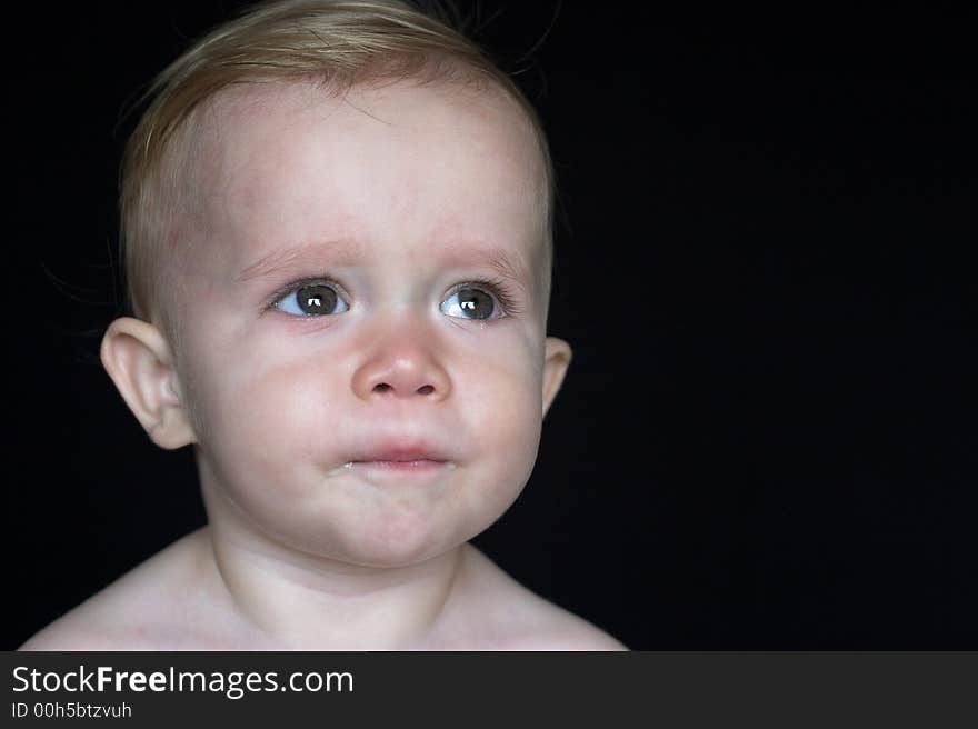 Image of beautiful toddler with a thoughtful look on his face