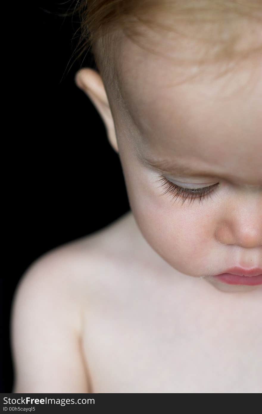 Image of beautiful toddler looking down