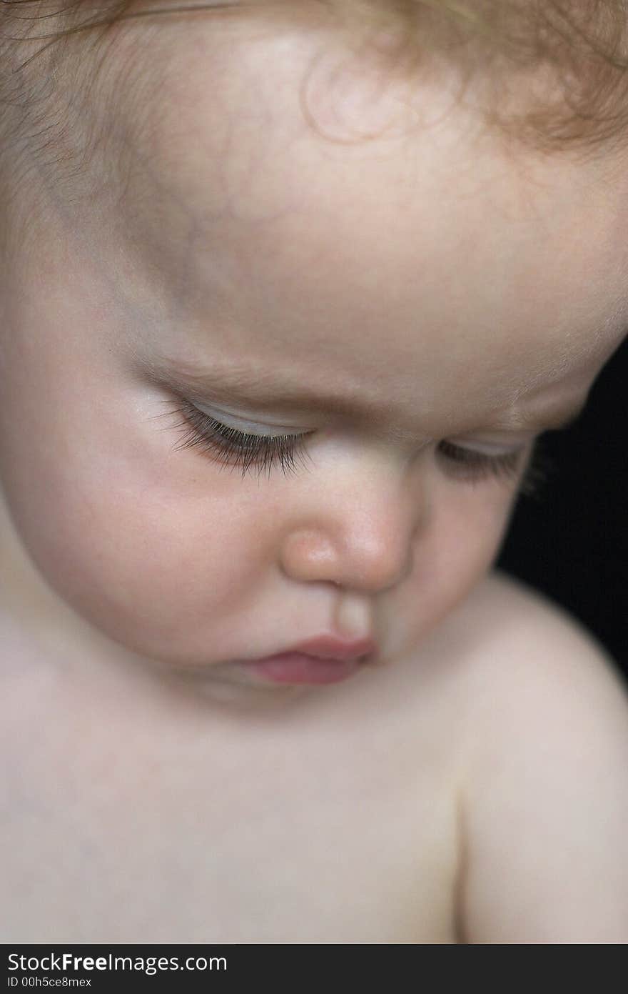 Image of beautiful toddler looking down