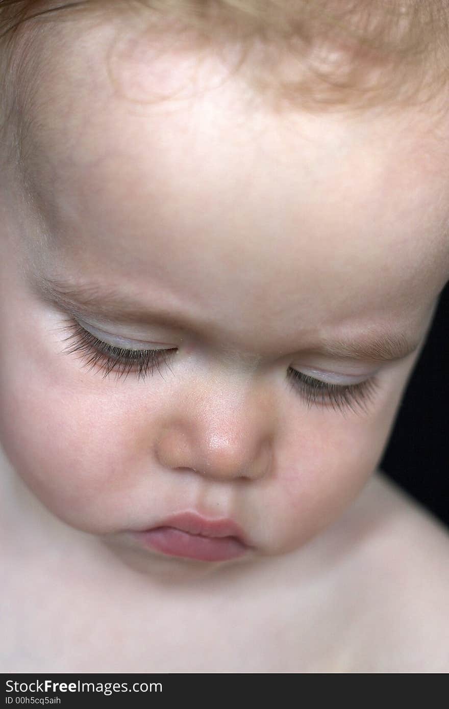 Image of beautiful toddler looking down