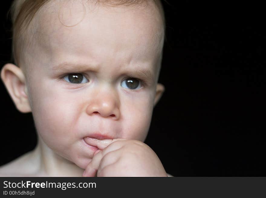 Image of beautiful toddler with a serious look on his face