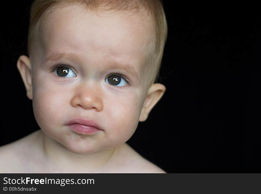 Image of beautiful toddler with a thoughtful look on his face