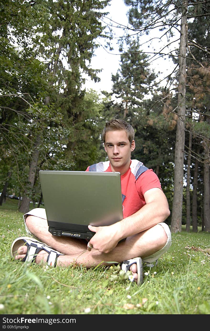 Picture of young man with notebook in park