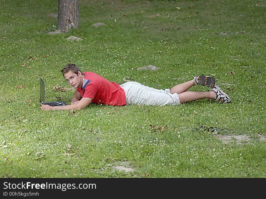 Picture of young man with notebook in park