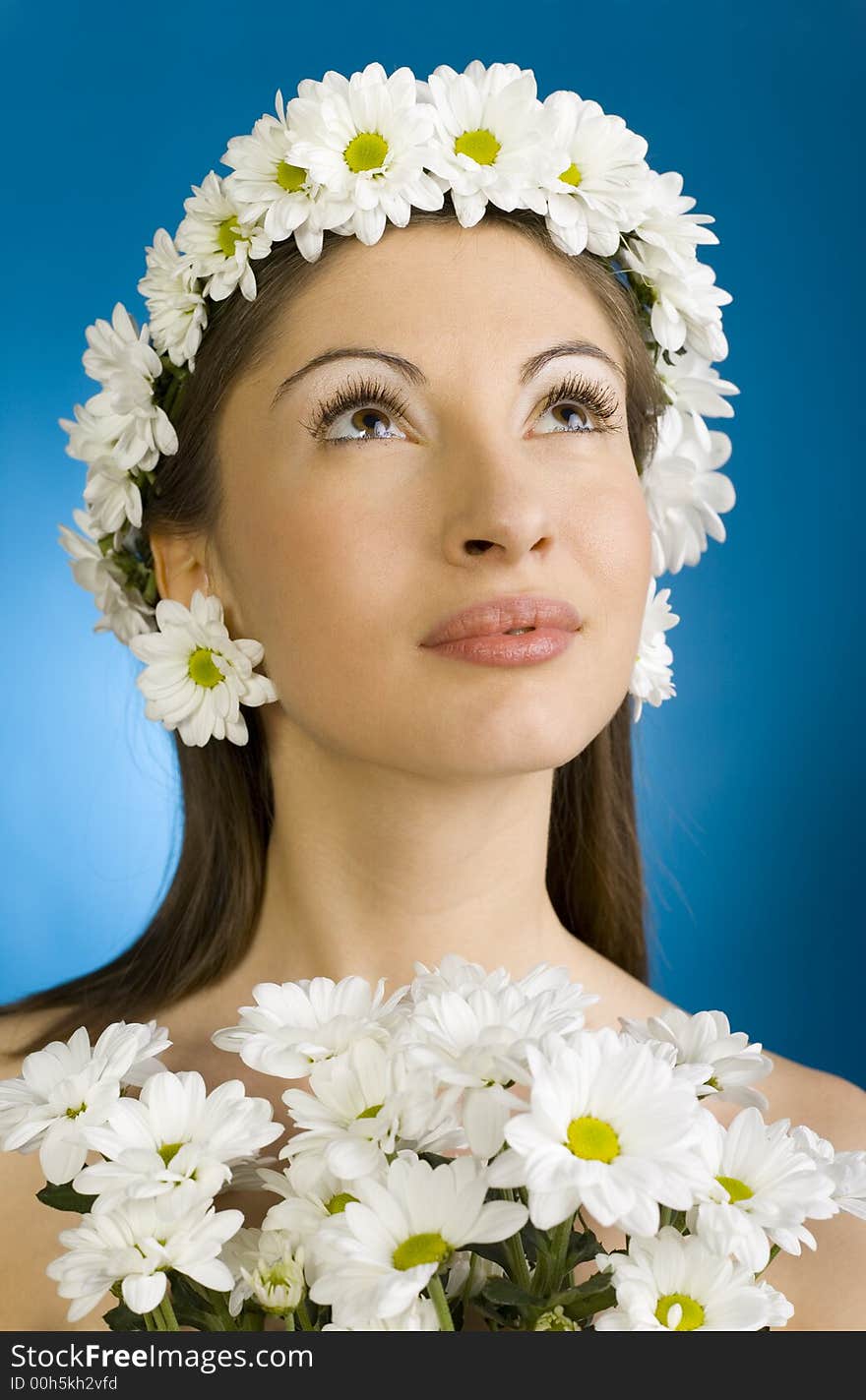 Young, beautiful and naked woman with bouquet of white flowers. Blue background. Young, beautiful and naked woman with bouquet of white flowers. Blue background