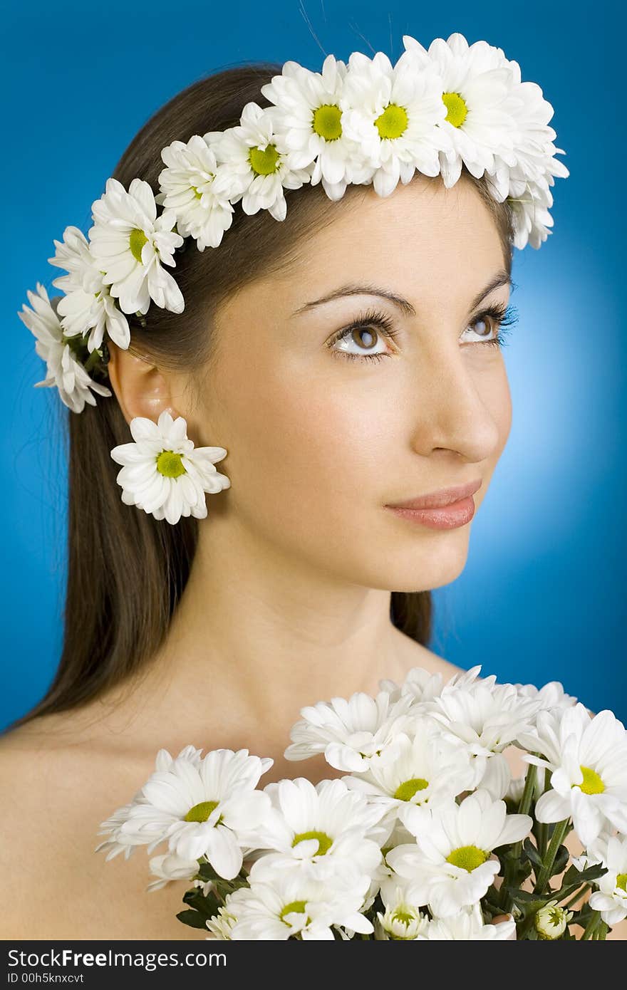 Young, beautiful and naked woman with bouquet of white flowers. Blue background. Young, beautiful and naked woman with bouquet of white flowers. Blue background