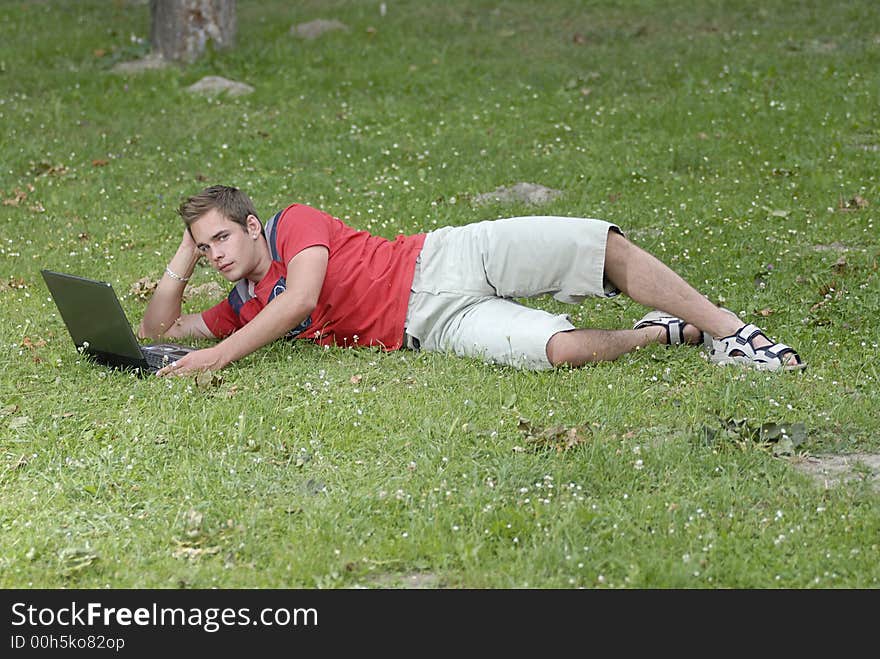 Picture of young man with notebook in park