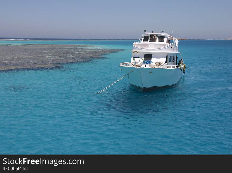 The ship standing in the sea near coral a reef. The ship standing in the sea near coral a reef