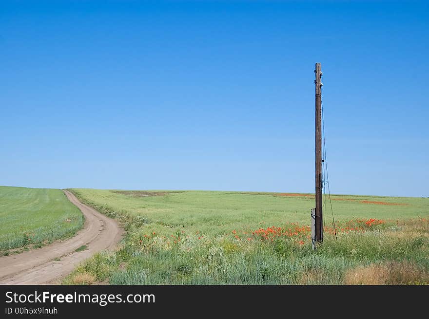 Rural landscape with green meadow, old telegraph pole and blue sky. Rural landscape with green meadow, old telegraph pole and blue sky