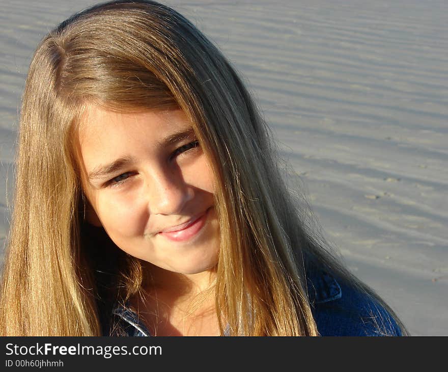 Young girl on the beach, friendly head & shoulders pose. Young girl on the beach, friendly head & shoulders pose