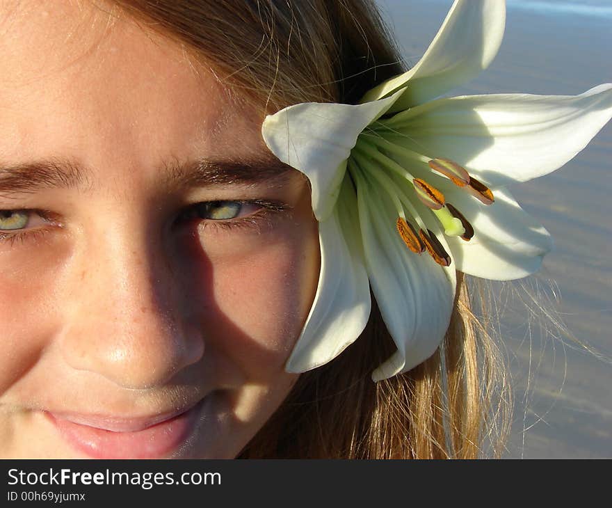 Young girl on the beach with a flower in her hair. Young girl on the beach with a flower in her hair