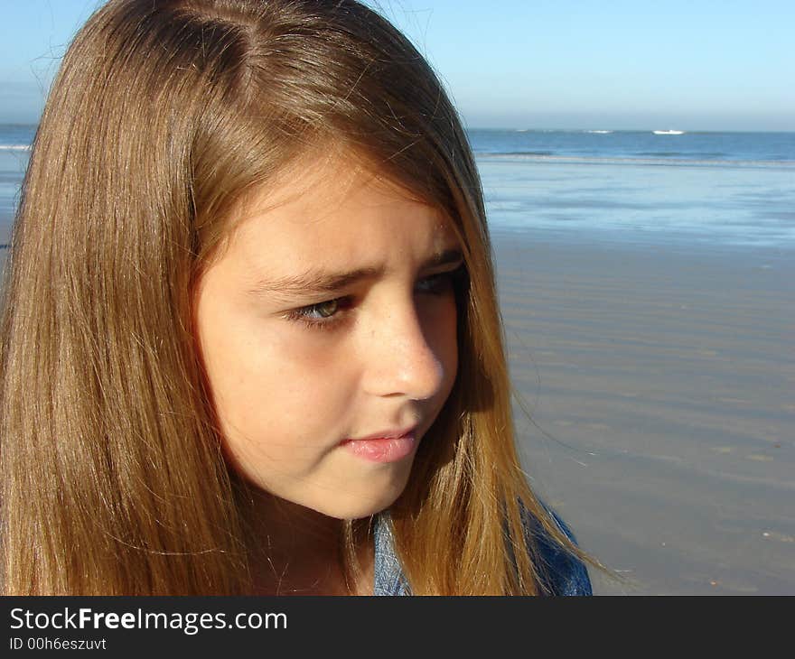 Half profile of a young girl on the beach, Head & Shoulders. Half profile of a young girl on the beach, Head & Shoulders