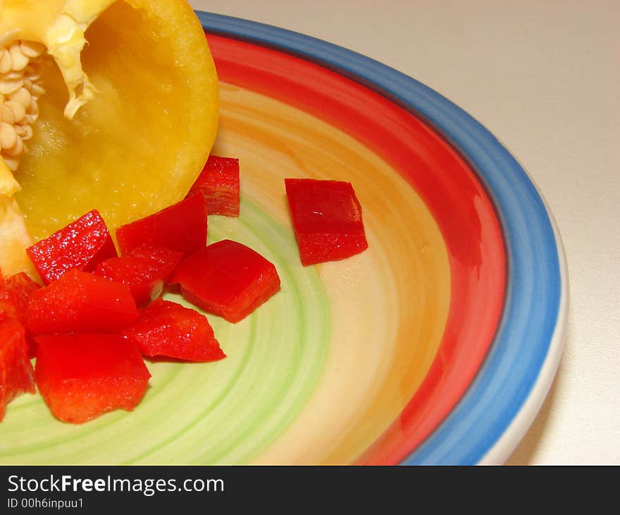 Red Peppers and Yellow Peppers on a coloured plate. Red Peppers and Yellow Peppers on a coloured plate