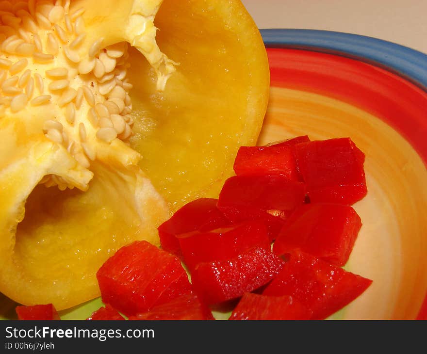 Yellow Peppers and Red Peppers on a colourful plate. Yellow Peppers and Red Peppers on a colourful plate