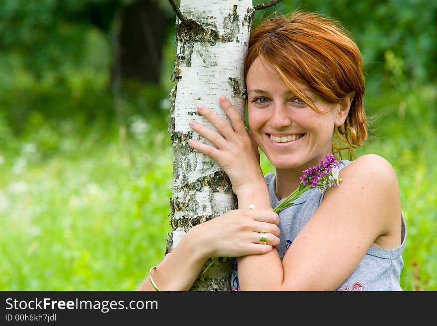 Smiling Girl And Birch Tree