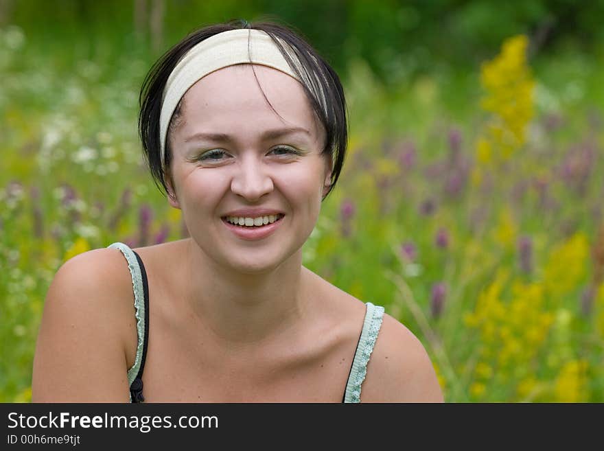 Smiling girl on meadow worn beige frontlet