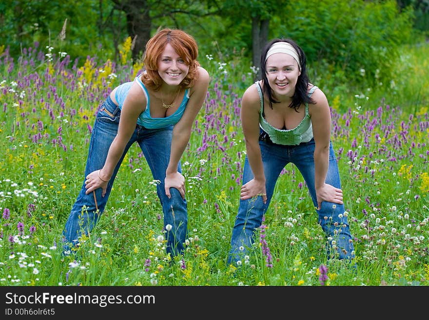 Smiling girls having fun on green meadow. Smiling girls having fun on green meadow