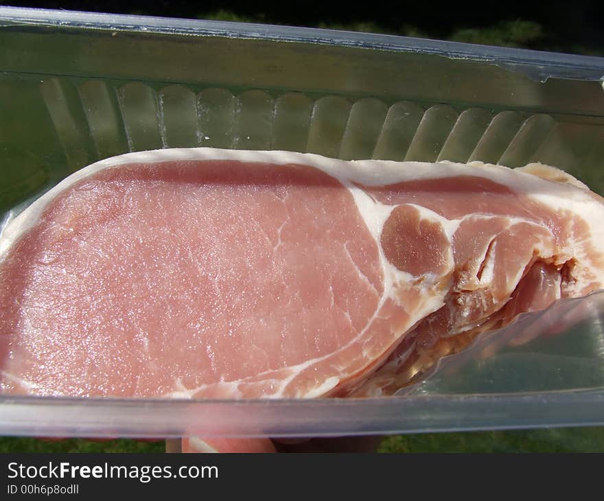 An image of some sliced bacon within its package.