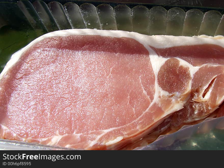 An image of some sliced bacon within its package.