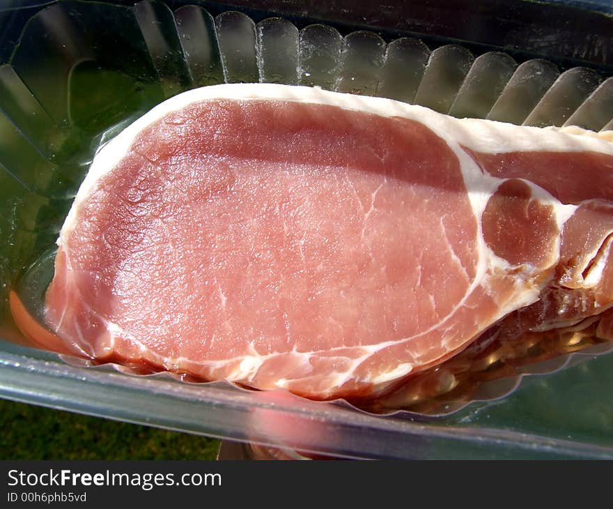 An image of some sliced bacon within its package.