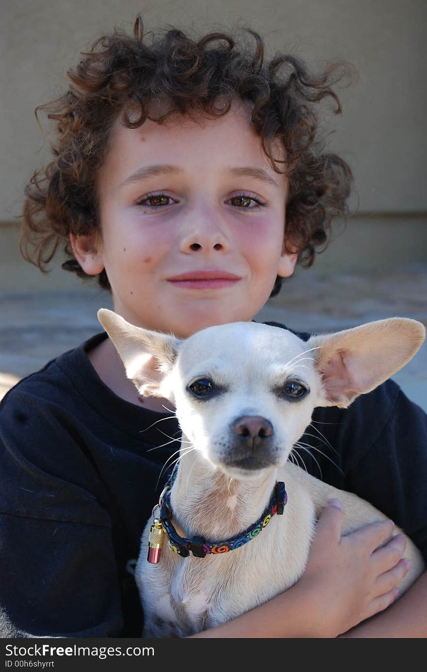 boy holding a little chiwawa dog