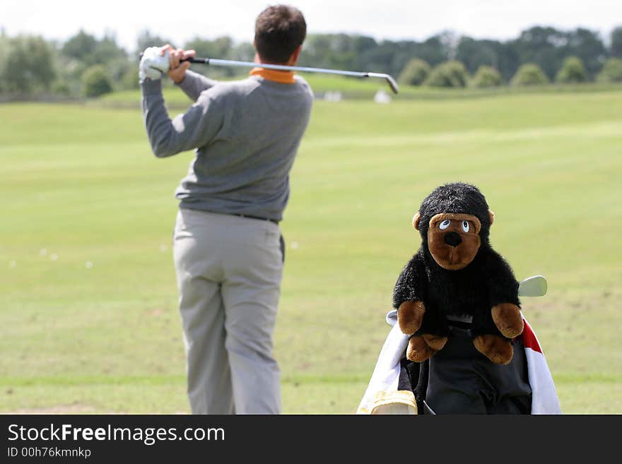 Man golf swing with monkey