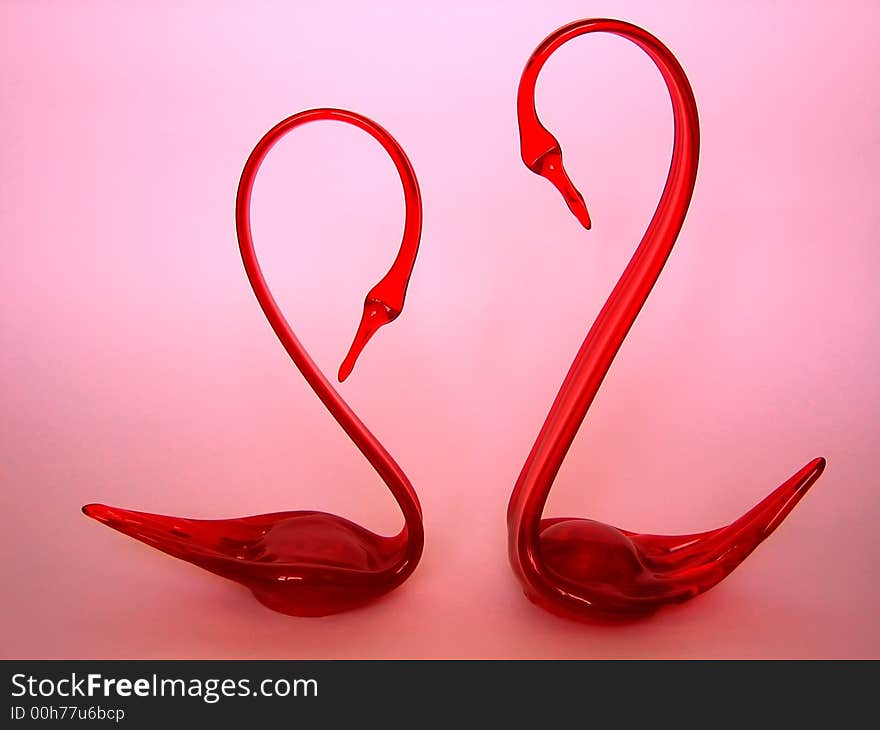 This is two swans stuettes from red glass. This is two swans stuettes from red glass.