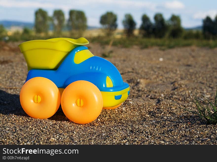 Toy car on a deserted playground at dusk - the perspective creates a reality-like, authentic feeling