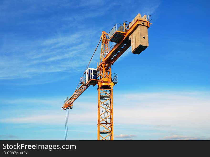 Tower crane before the sky background