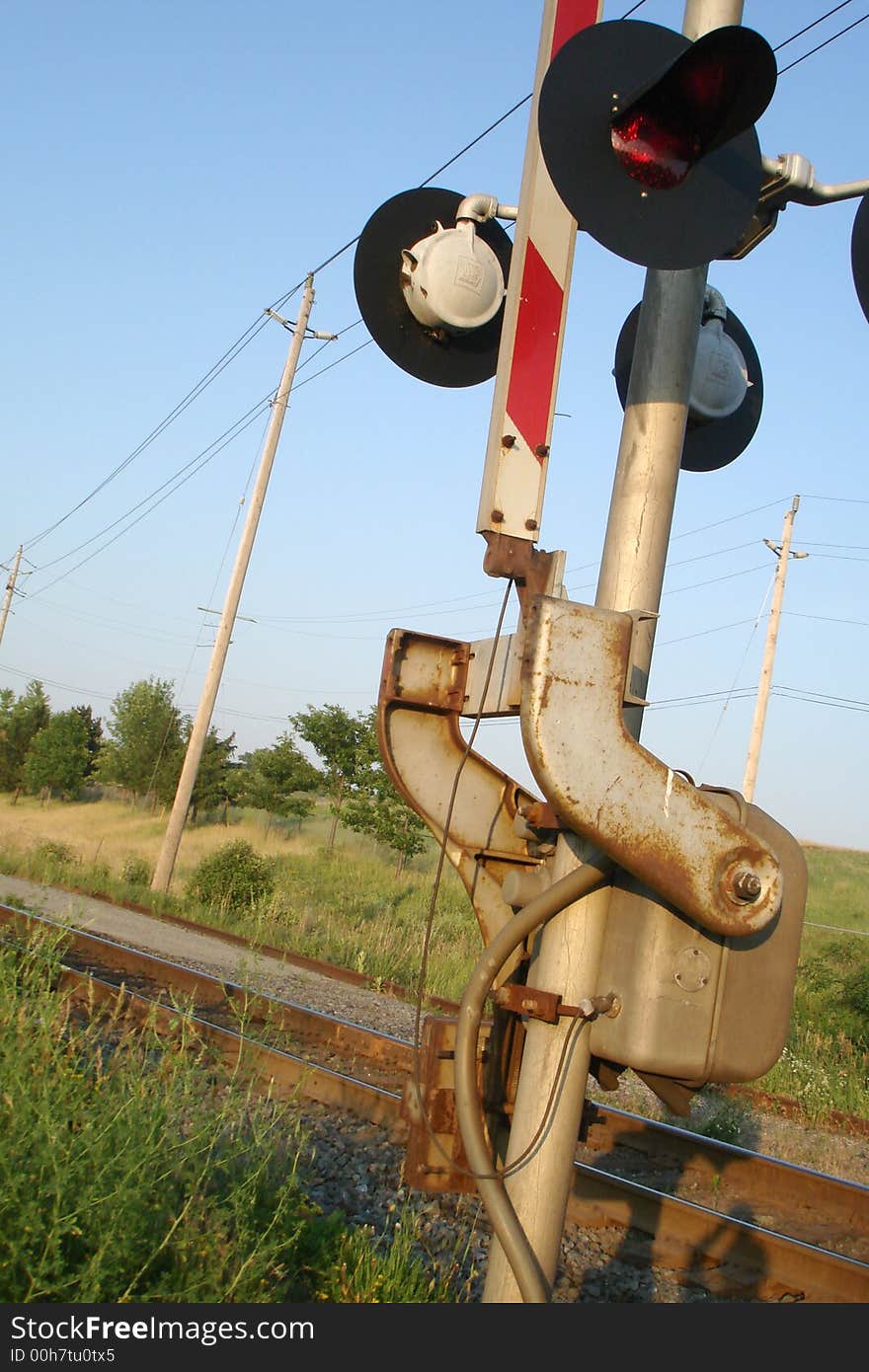 A railroad crossing signal by the tracks