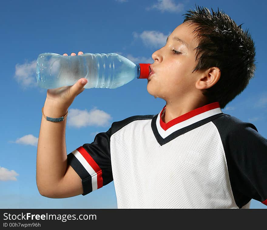 Thirsty boy drinking water out