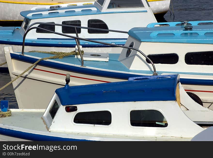 Three blue and white boats