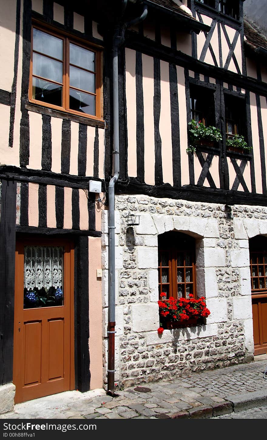 Timber Framed Village House in Normandy, France with pretty flower filled window boxes. Timber Framed Village House in Normandy, France with pretty flower filled window boxes