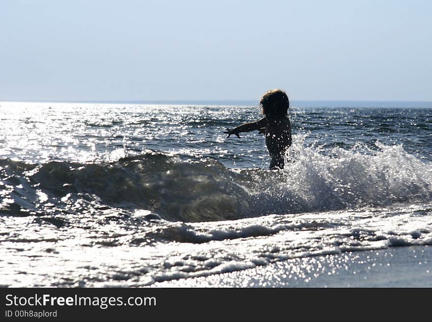 Silhouette of baby in the sea