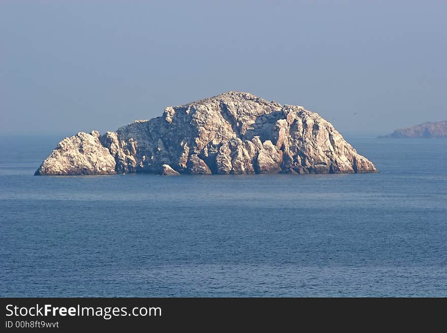 Massive rocks in the ocean off the coast. Massive rocks in the ocean off the coast