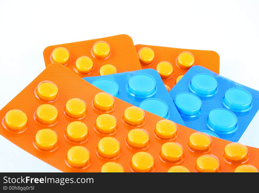 Tablets and vitamin pills in different shapes and colors. Tablets and vitamin pills in different shapes and colors